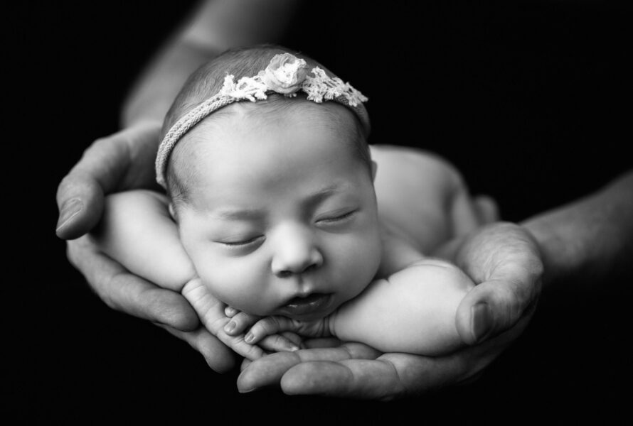 Newborn baby in father's hands in Charlottesville Virginia
