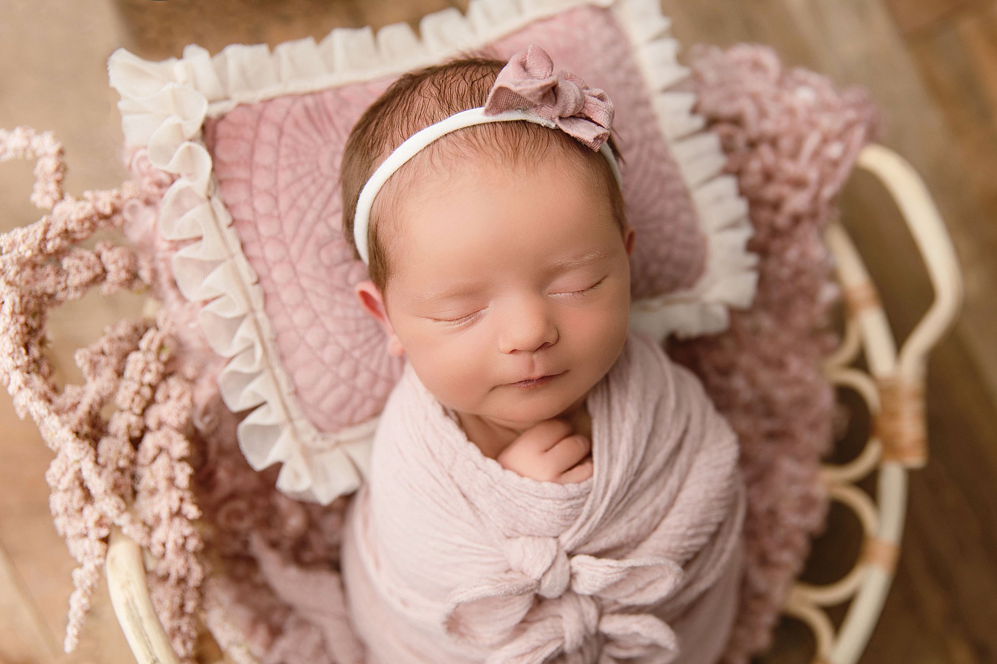 baby girl wrapped in pink for swaddled newborn session