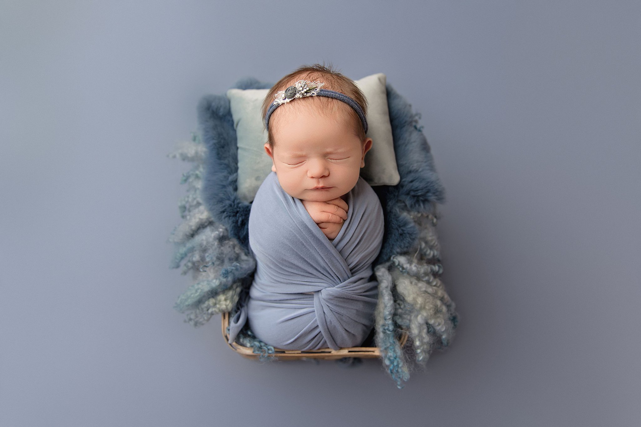 blue headband and wrap on infant for swaddled newborn session