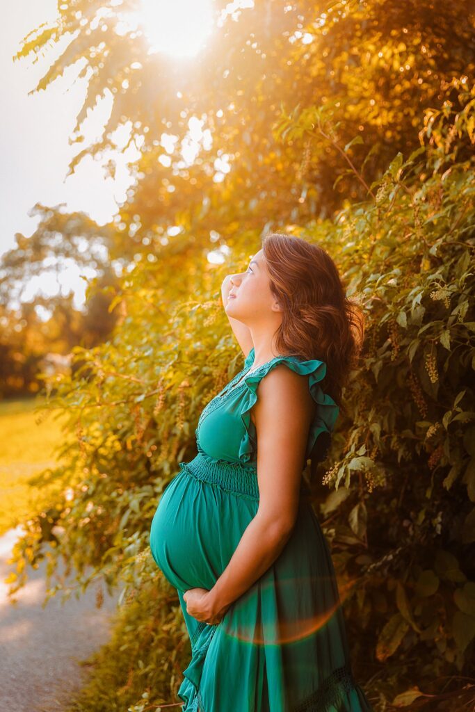 woman looks up toward sun during golden hour by Amy Yang Photography