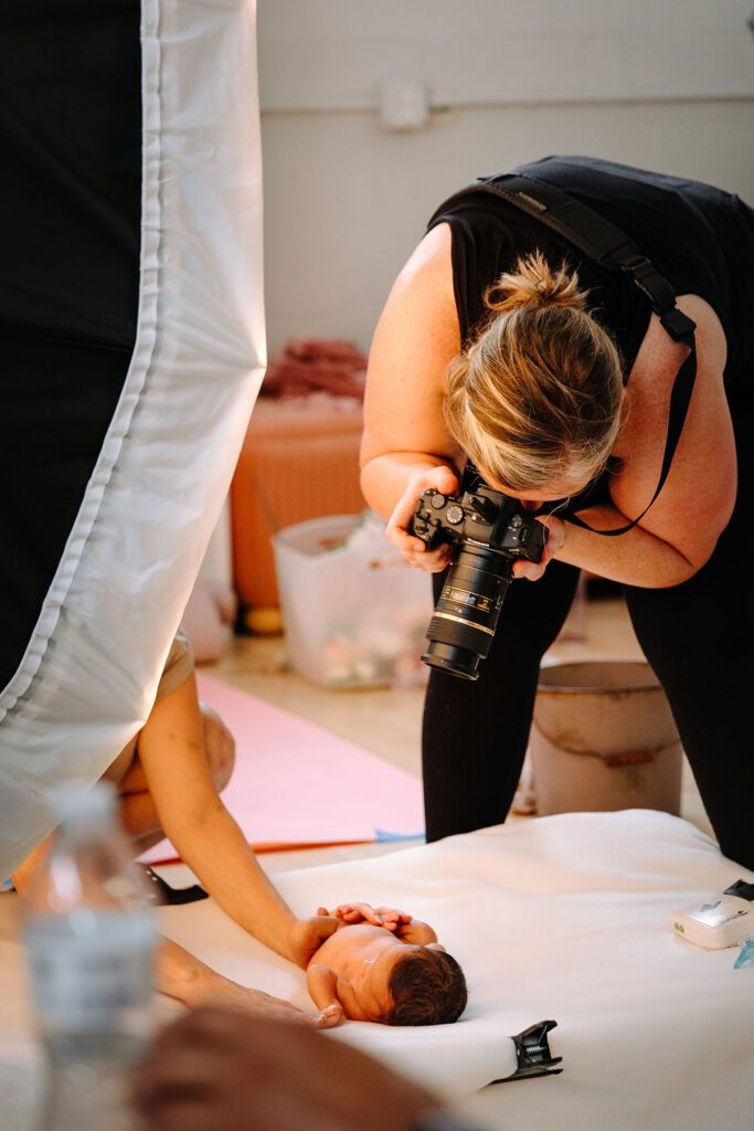 Behind the scenes newborn photography capturing a newborn session in the studio.