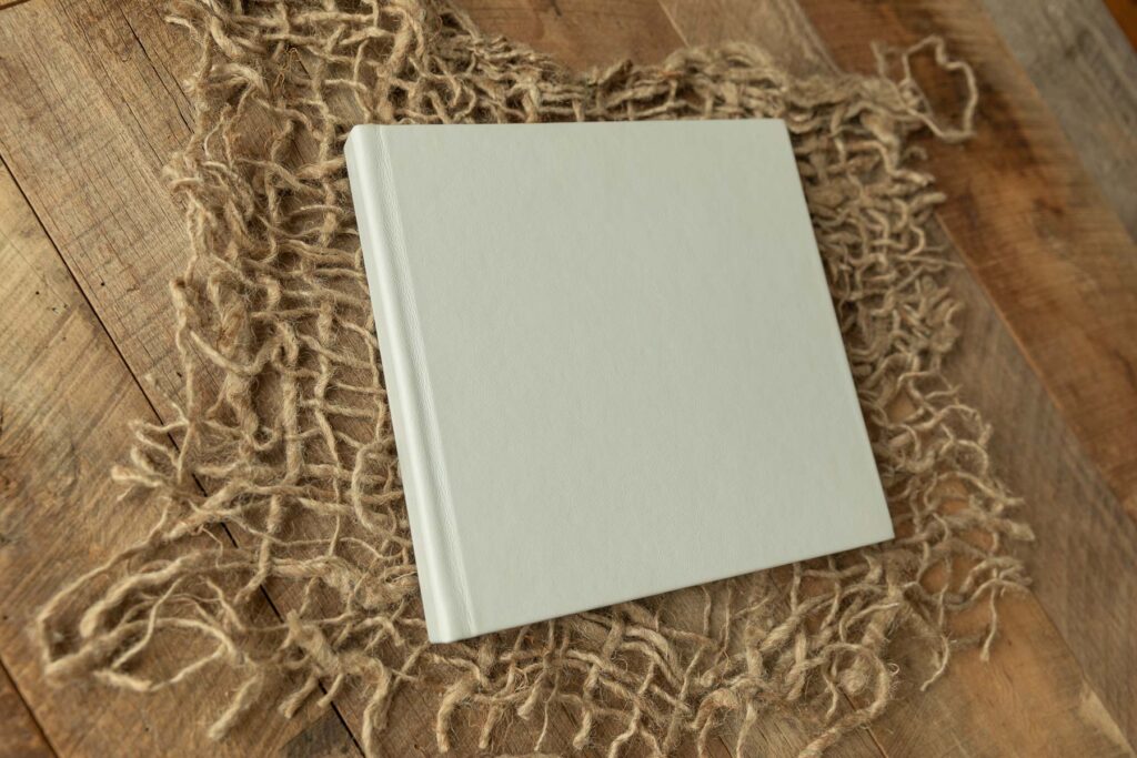 Linen cover of a custom newborn photo album.