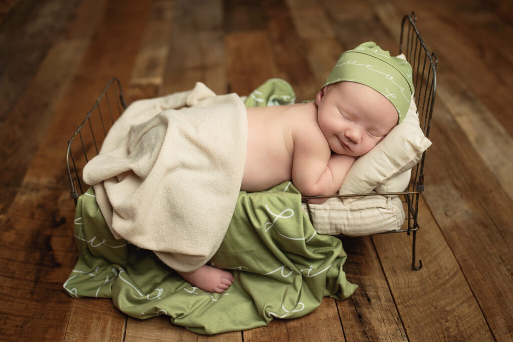 Newborn peacefully sleeping in a vintage bed prop during a 2-4 hour newborn session in Richmond, VA.