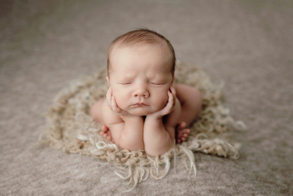 Newborn resting in a classic pose, demonstrating what actually happens during a 2-4 hour newborn session with safe, unhurried posing.