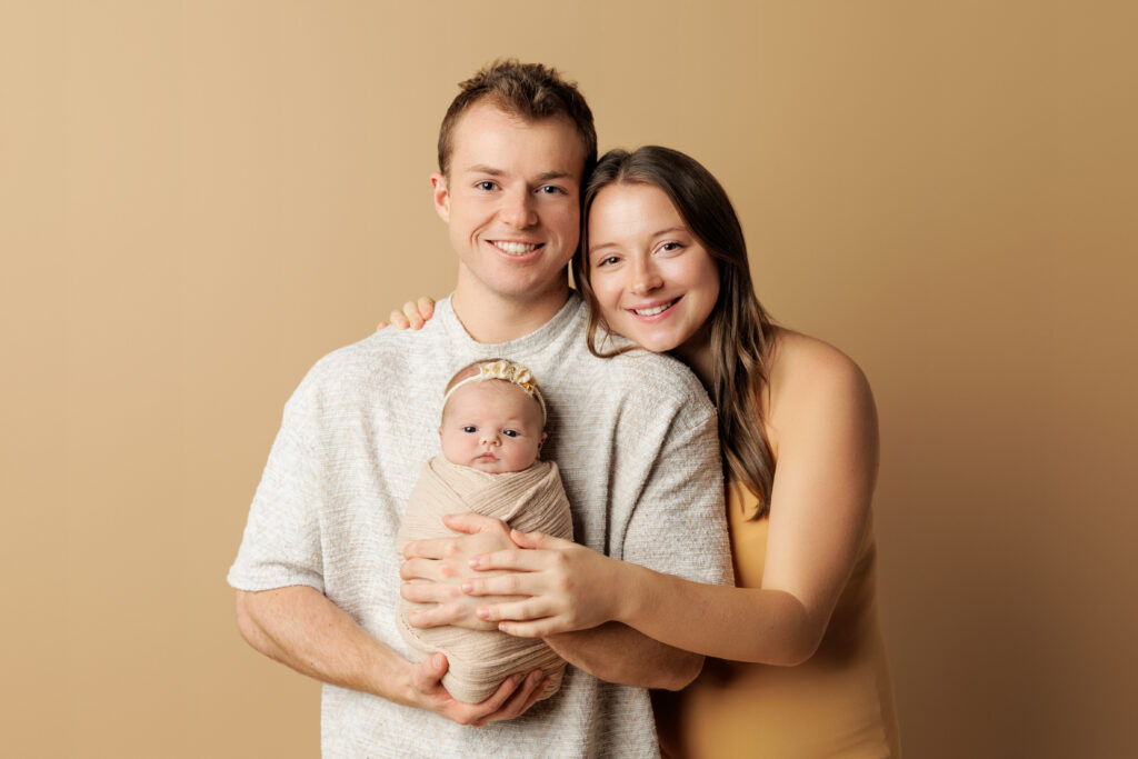 Parents holding their newborn baby during a family portrait session with Amy Yang Photography.