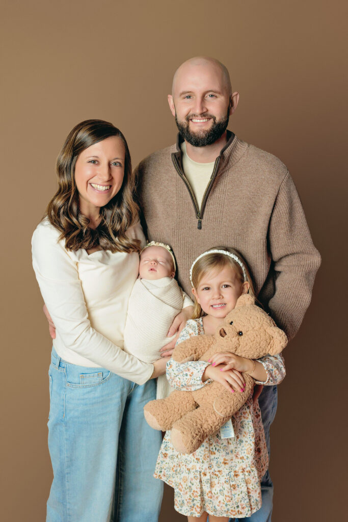 Parents with their newborn baby and big sister during a Charlottesville newborn portrait session.